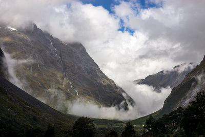 Scenic view of mountains against cloudy sky