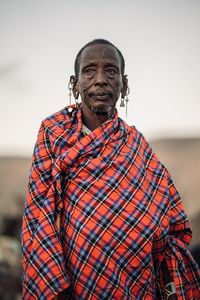 Portrait of man standing against wall