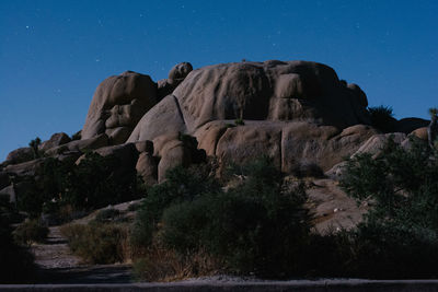 Low angle view of rock formations against sky