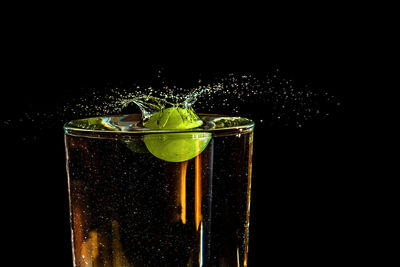 Close-up of wine glass against black background