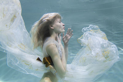 Side view of woman looking at swimming pool