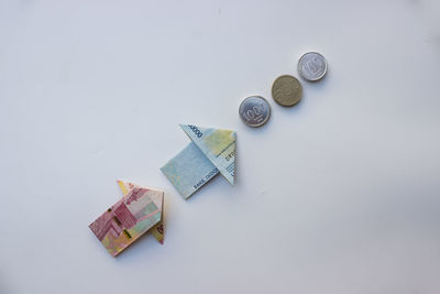 High angle view of paper currency on white background