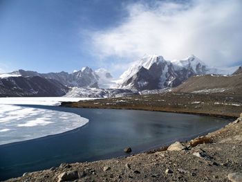 Scenic view of mountains against cloudy sky