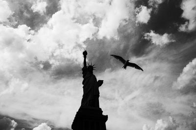 Low angle view of statue against cloudy sky