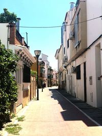 Empty alley amidst buildings in city
