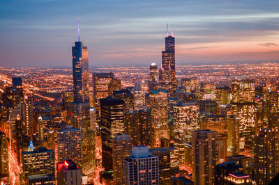 Aerial view of city lit up at night