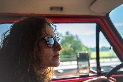 Close-up of woman wearing sunglasses in car