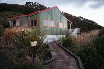 House by plants against sky