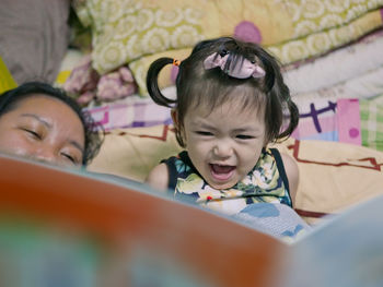 Portrait of a smiling young woman reading book
