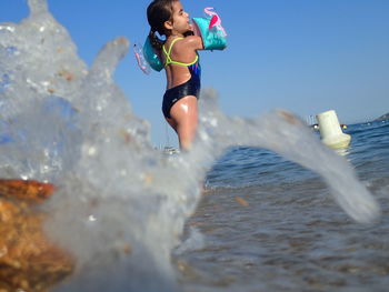 Full length of young woman in sea