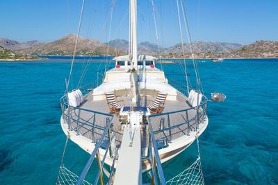 Sailboat sailing on sea against clear sky