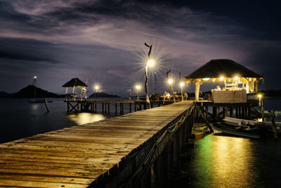 Boats in sea at sunset