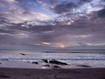 Scenic view of beach against sky during sunset