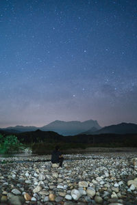 Scenic view of rocks at night against sky