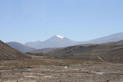 Scenic view of landscape and mountains against clear blue sky