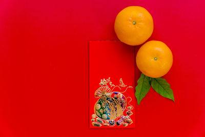 Close-up of orange fruits against red background