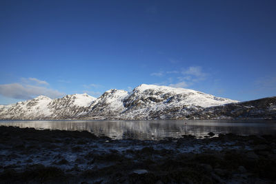 Scenic view of lake and snowcapped mountains against sky