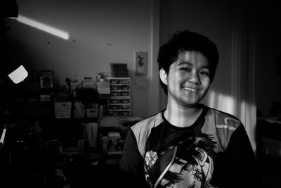 Portrait of young man standing at home