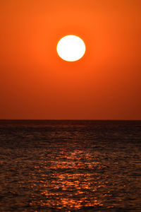 Scenic view of sea against orange sky