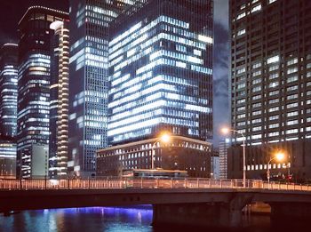 Illuminated modern buildings in city at night