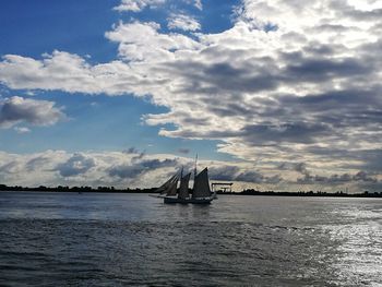 Boat sailing in sea against sky