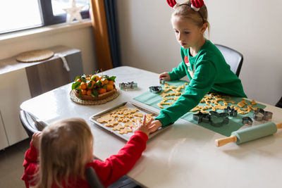 High angle view of mother and daughter at home