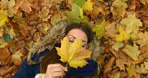 Portrait of woman holding autumn leaves