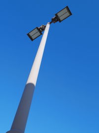 Low angle view of floodlight against clear blue sky
