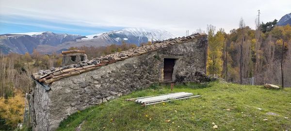 Built structure on field against sky