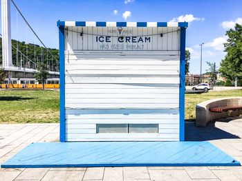 Information sign against blue sky