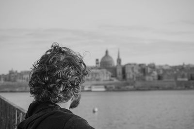 Young man looking at river