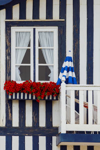 Typical colourful houses with grey and white stripes in costa nova - aveiro against sky