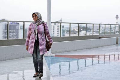 Full length of woman walking against sky