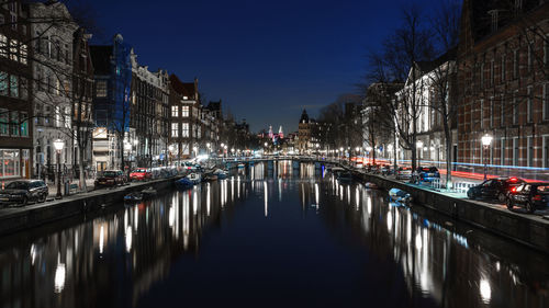 Illuminated canal at night