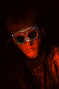 Close-up portrait of boy wearing illuminated goggles