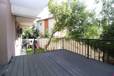 Footpath amidst trees and buildings