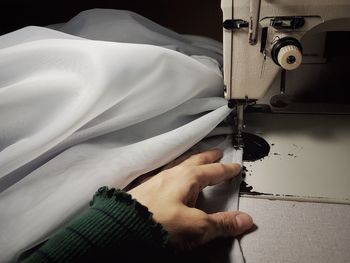 Close-up of person holding hands on fabric