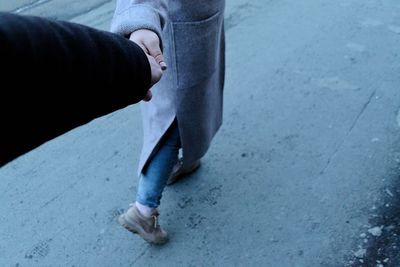 Low section of man with cigarette on street