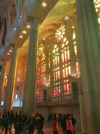 Low angle view of people in illuminated building