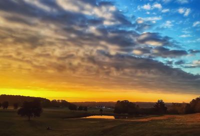 Silhouette landscape against sky during sunset