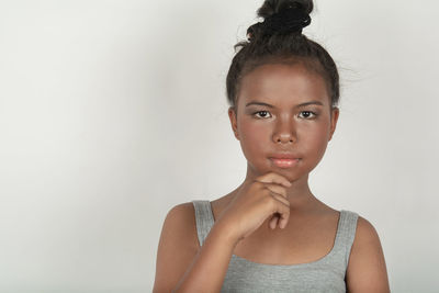 Portrait of a young woman against white background
