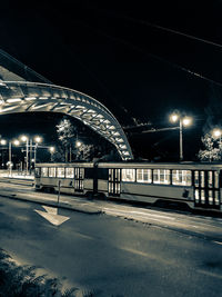 Illuminated bridge against sky at night