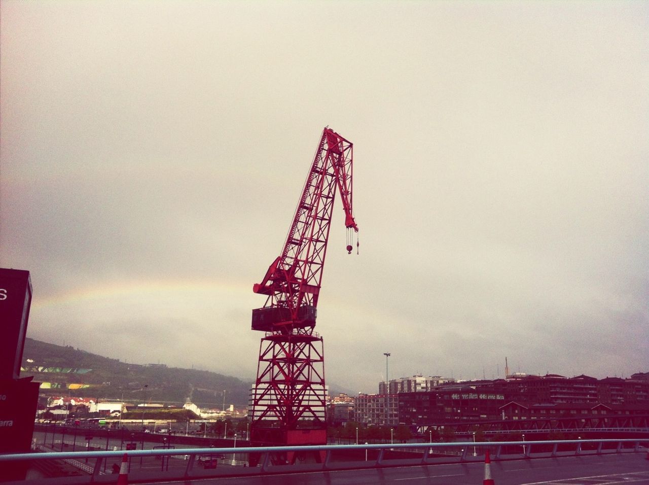 built structure, architecture, sky, building exterior, metal, low angle view, development, connection, bridge - man made structure, tower, industry, engineering, crane - construction machinery, construction site, travel destinations, red, suspension bridge, city, tall - high, cloud - sky