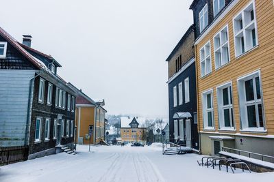 Houses in winter against sky