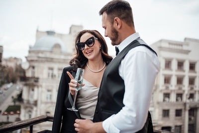 Young couple standing in front of a city