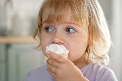 Close-up of young woman holding ice cream