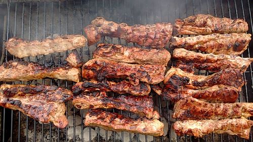 High angle view of meat grilling on barbecue grill