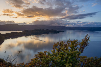 Scenic view of lake against sky during sunset