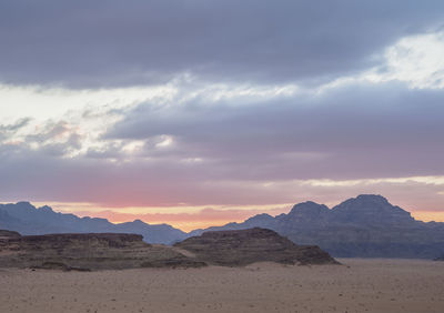 Scenic view of desert against sky during sunset