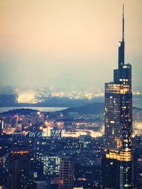 Illuminated cityscape against sky at night